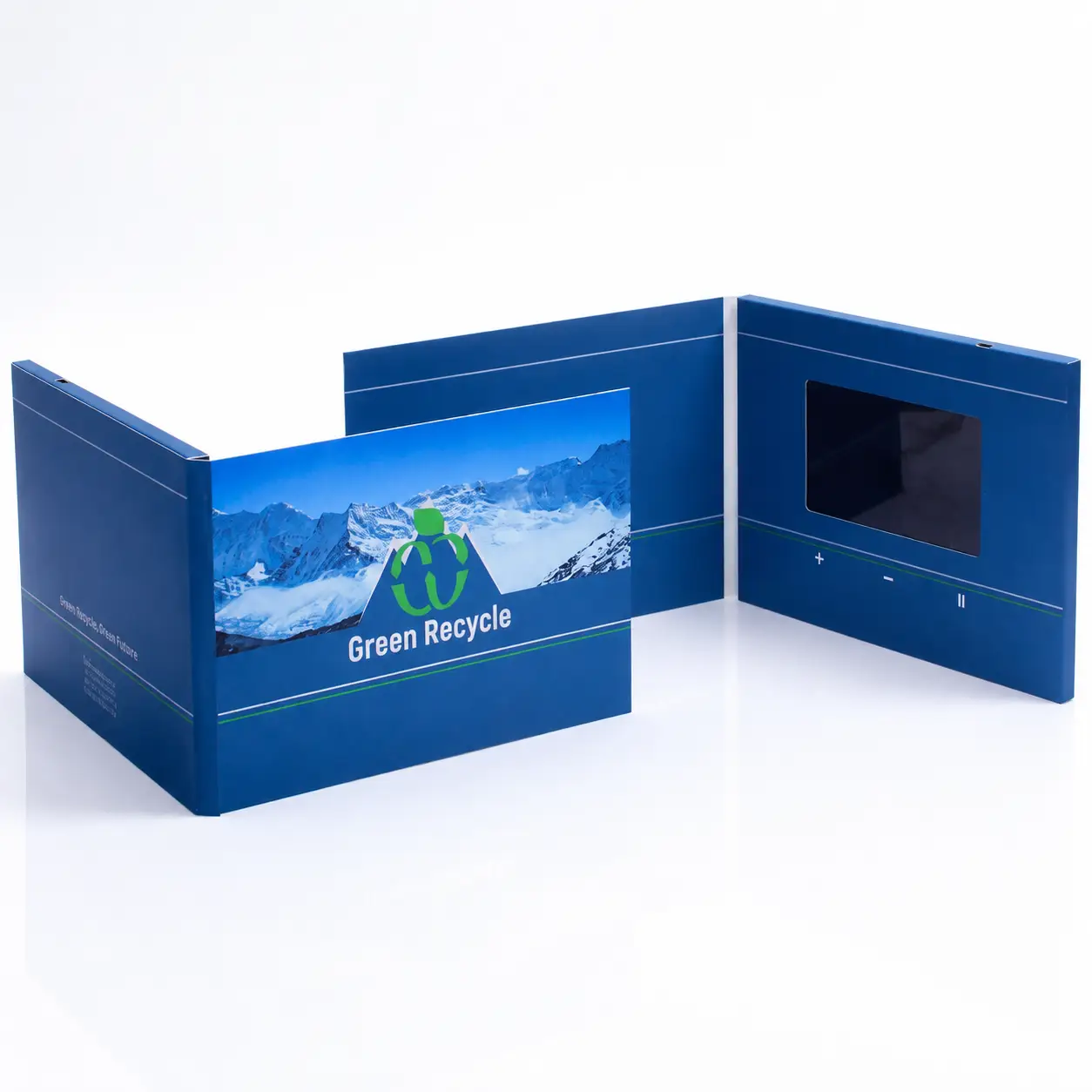 Close-up of an LCD video screen embedded in a printed video brochure cover, playing a real estate listing video