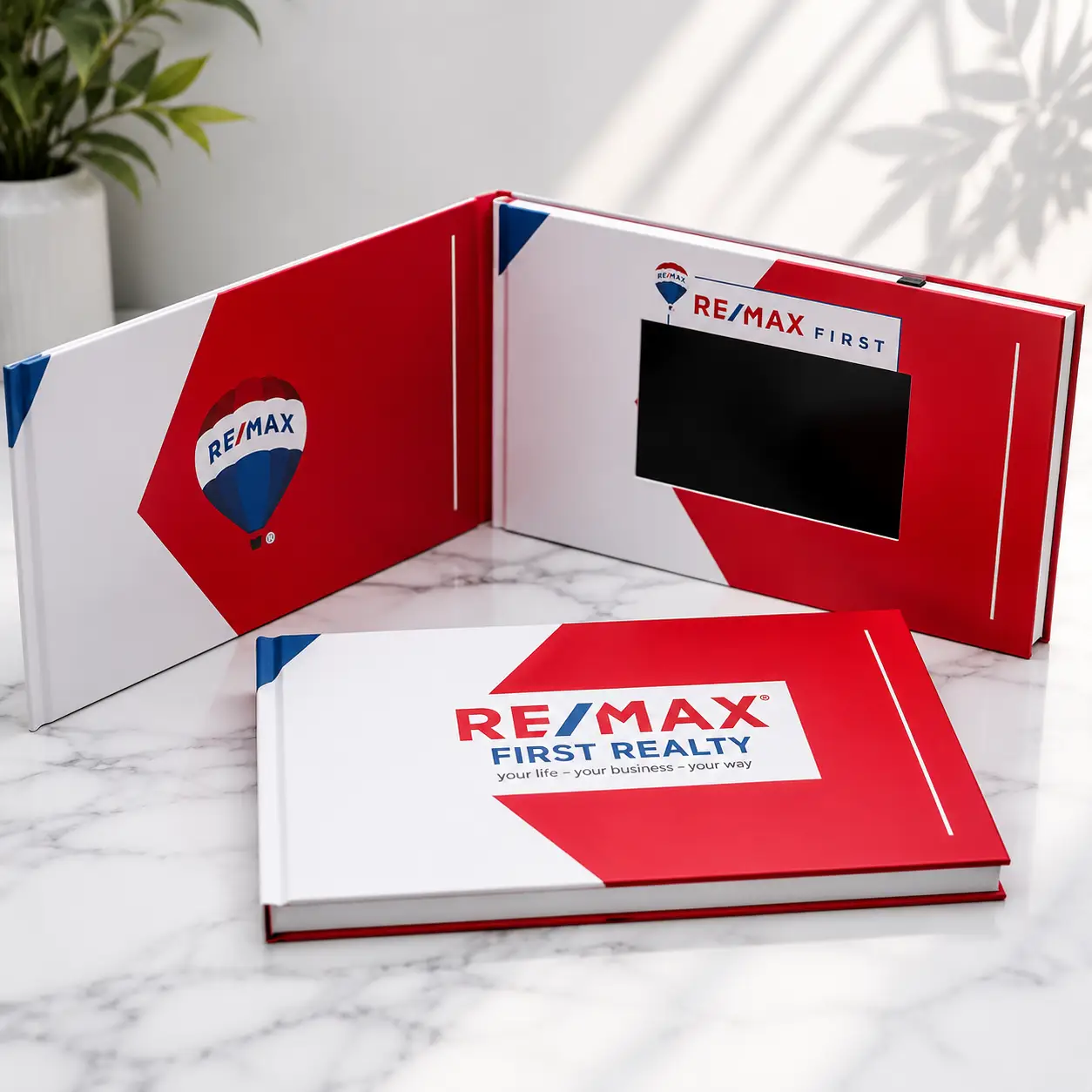 Sample video brochures in 5 inch, 7 inch, and 10 inch sizes with different cover finishes laid out for comparison